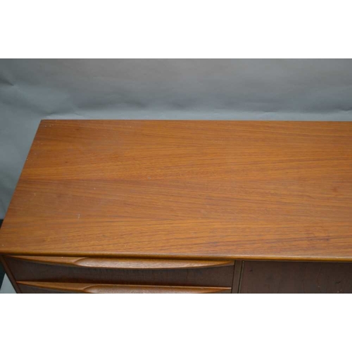 317 - A McINTOSH BRANDED TEAK LONG AND LOW SIDEBOARD, having a combination of cupboard doors, drawers and ... 