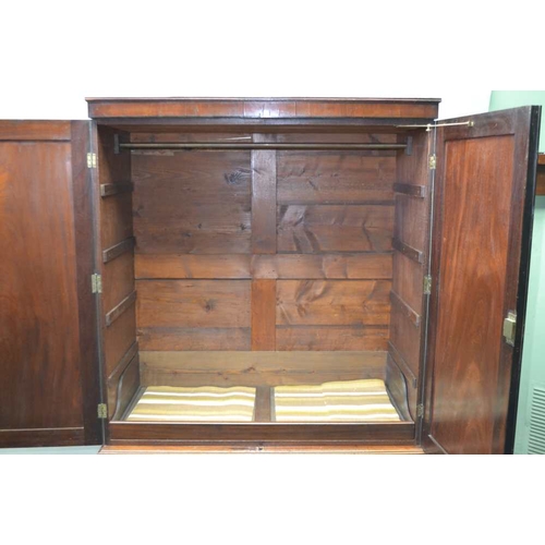 290 - A 19TH CENTURY MAHOGANY LINEN PRESS, plain frieze over two doors, opening to reveal one slide, on a ... 