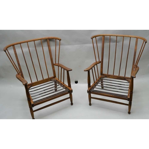 305 - A PAIR OF MID-CENTURY ELM & BEECH STICK BACK WING ARMCHAIRS in the manner of Ercol, having associate... 