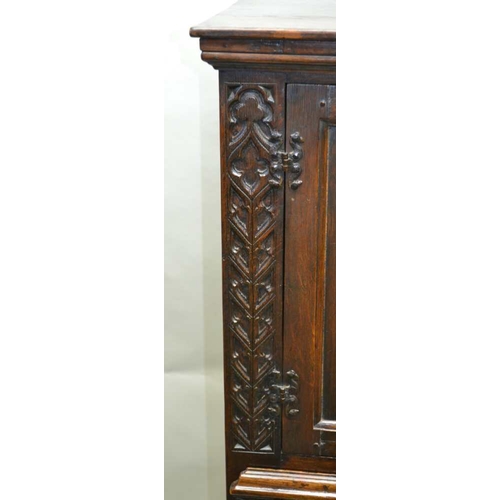 261 - A 20TH CENTURY OAK COCKTAIL CABINET, in the 17th century style, with linen fold and blind fret decor... 