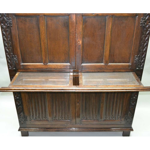 261 - A 20TH CENTURY OAK COCKTAIL CABINET, in the 17th century style, with linen fold and blind fret decor... 