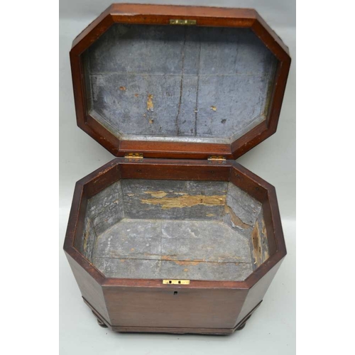 294 - AN EARLY 19TH CENTURY MAHOGANY CELLARET of tapering canted form, having hinged cover, fitted brass r... 