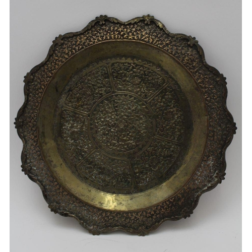 14 - A pair of early 20th century white metal Far Eastern plates, pointed edge, repousse and chased decor... 