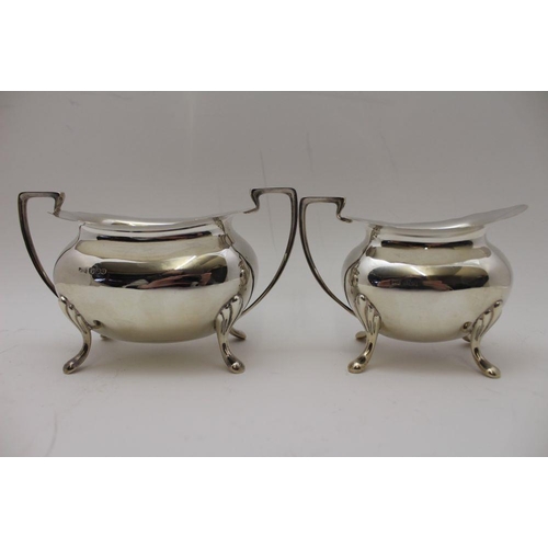 2 - A Walker & Hall four piece silver tea set, comprising; teapot, hot water pot, milk jug, and a two-ha... 