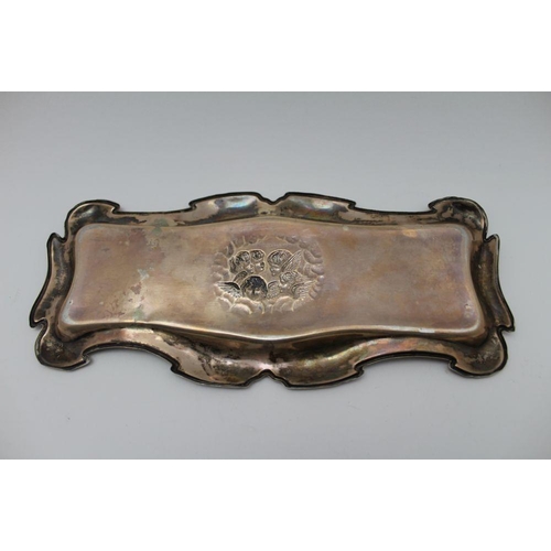 23 - William Devenport, An Edwardian silver dressing table tray, shaped form, embossed cherub decoration ... 