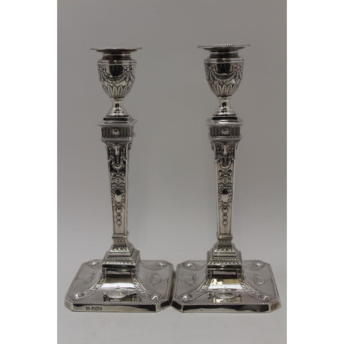 3 - James Deakin & Sons, A pair of late Victorian silver candlesticks of Adam design, the urn form sconc... 