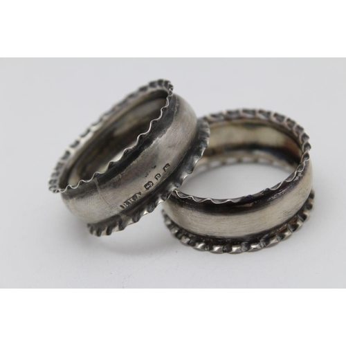 40 - Barnett Henry Abrahams, a pair of silver napkin rings, Birmingham 1898, with fluted rims, together w... 