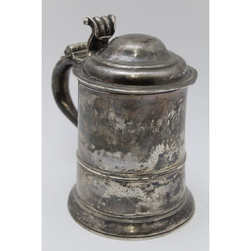 5 - A George II silver lidded tankard, having domed cover with scrolled thumbpiece, the tapering cylindr... 