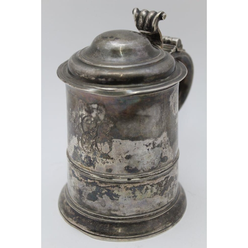 5 - A George II silver lidded tankard, having domed cover with scrolled thumbpiece, the tapering cylindr... 