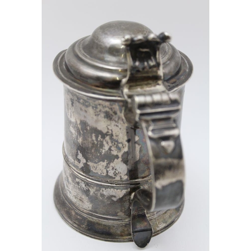 5 - A George II silver lidded tankard, having domed cover with scrolled thumbpiece, the tapering cylindr... 