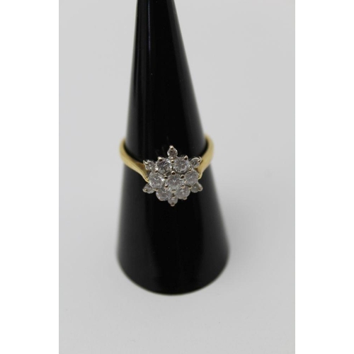 65 - A diamond cluster ring, flower head form, brilliant cut central stone, surrounded by six diamonds wi... 