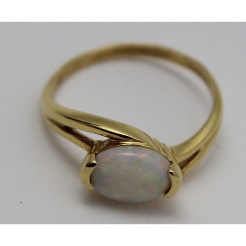 73 - An 18k gold ring set an oval cabochon opal, gross weight: 3.6g, ring size: 'P' (in heart shaped ring... 