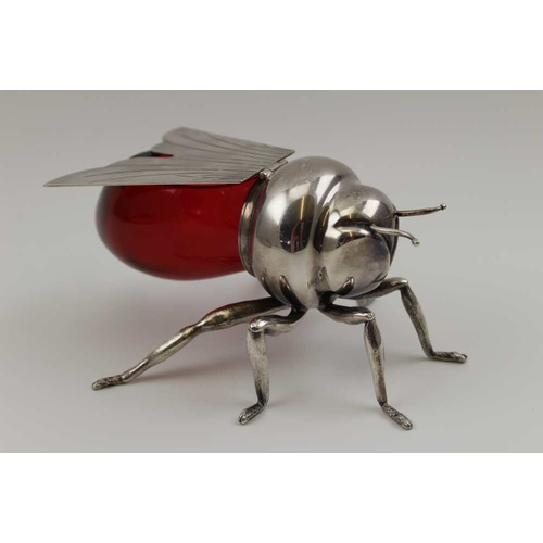 15 - Mappin & Webb, A silver plated bee form honey pot, with cranberry glass body, having hinged wing lid... 