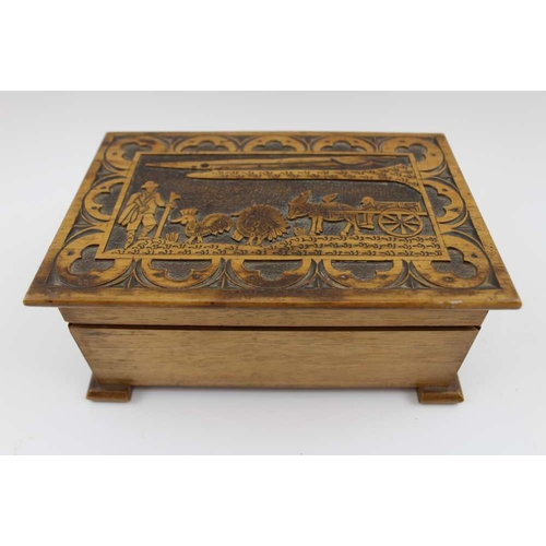 152 - A 20th century Sicilian walnut cigarette box, the hinged cover, carved in a folk-art manner, with an... 