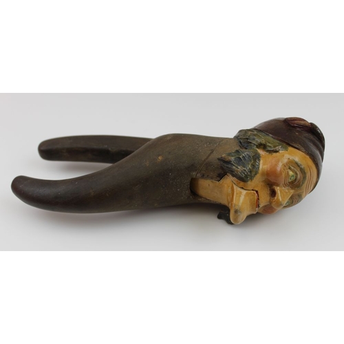 159 - A mid 20th century carved wood Black Forest nutcracker, in the form of a man's head with sideburns a... 