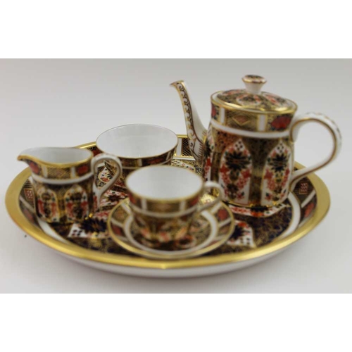 81 - A Royal Crown Derby miniature tea set, decorated in the Imari pattern, No.1128, comprising; oval tra... 