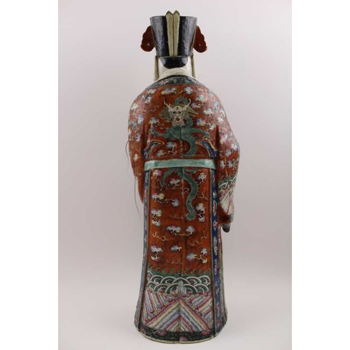 85 - An early 20th century Chinese ceramic Immortal, carrying a Ruyi sceptre, polychrome painted in an el... 