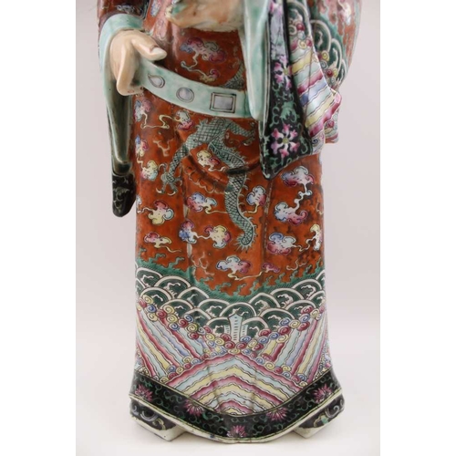 85 - An early 20th century Chinese ceramic Immortal, carrying a Ruyi sceptre, polychrome painted in an el... 