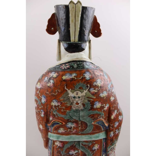 85 - An early 20th century Chinese ceramic Immortal, carrying a Ruyi sceptre, polychrome painted in an el... 