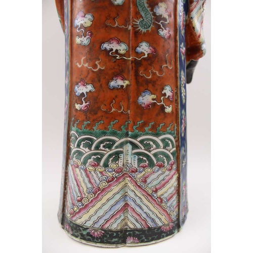 85 - An early 20th century Chinese ceramic Immortal, carrying a Ruyi sceptre, polychrome painted in an el... 