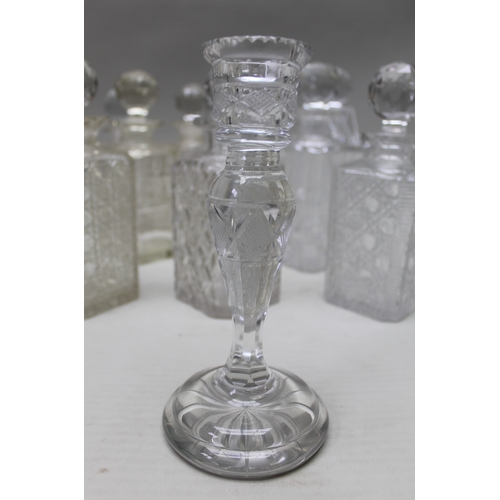 97 - A collection of ten square form spirit decanters, with facet cut stoppers, together with a cut glass... 