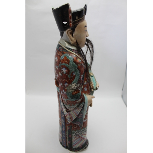 85 - An early 20th century Chinese ceramic Immortal, carrying a Ruyi sceptre, polychrome painted in an el... 