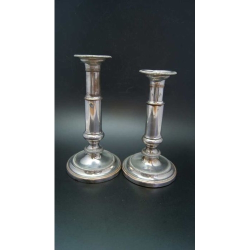 108 - A pair of early 19th century Old Sheffield plate telescopic candlesticks, on circular bases, extende... 