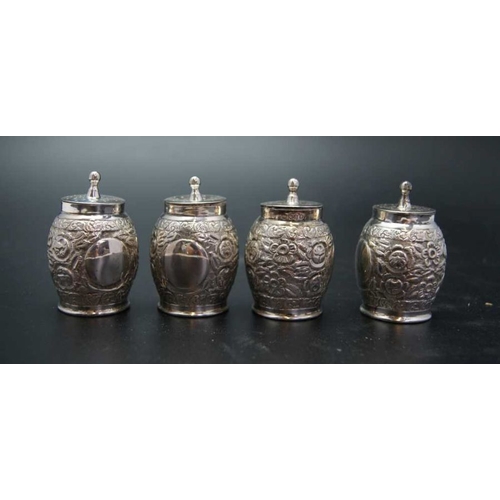 110 - Edward Hutton, a cased set of four of Victorian pepper pots, embossed decoration, London 1889, combi... 