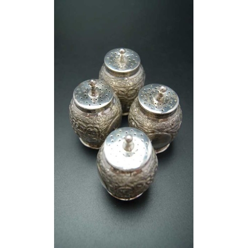 110 - Edward Hutton, a cased set of four of Victorian pepper pots, embossed decoration, London 1889, combi... 