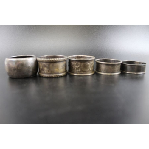 148 - A collection of five various silver napkin rings, combined weight: 103g, together with two Eastern d... 