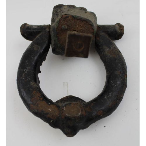 175 - A Victorian cast iron door knocker in the form of a wreath with lion mask, held in a clenched fist, ... 