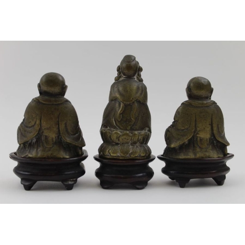 178 - Three 19th century cast brass Eastern Deities / Buddhas, each raised upon wooden plinth bases, the t... 