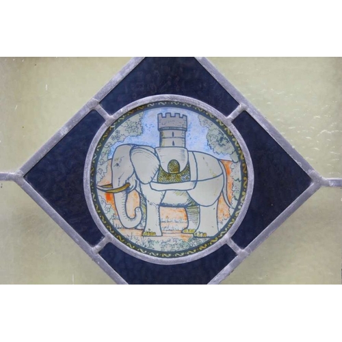 186 - A first quarter 20th century multi-coloured leaded glass panel, with elephant and castle central mot... 