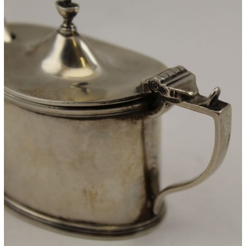 56 - A silver mustard with blue glass liner, together with a non-matching spoon, Birmingham 1921, 79g