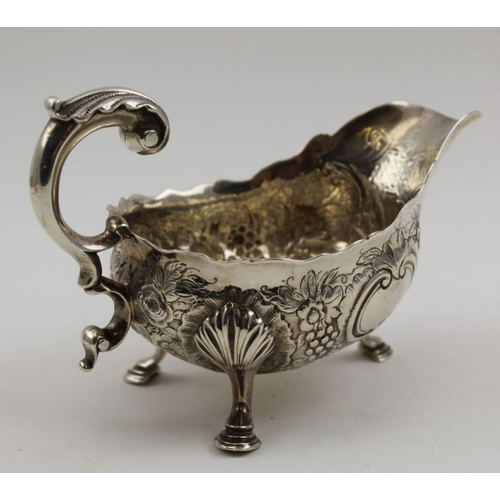 9 - William & Robert Peaston, a George II silver sauce boat,  embossed, London 1758, 234g