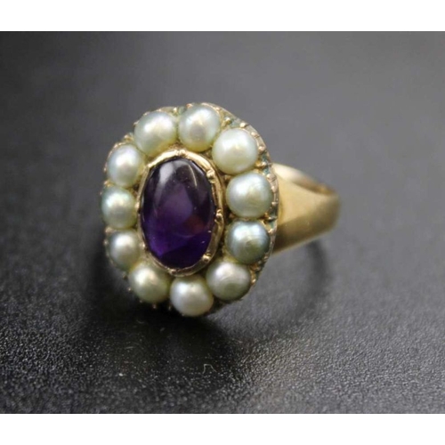 106 - An 18ct gold ring, inset central amethyst cabochon, surrounded by eleven pearls, ring size; 