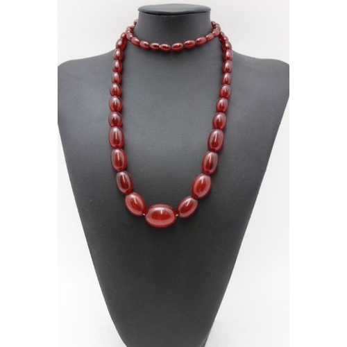 110 - A cherry amber bakelite graduated necklace, 88cm long. weight 88g.