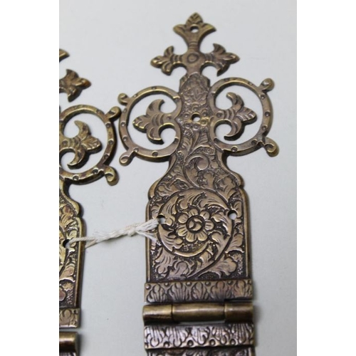 112 - A collection of twelve engraved and pierced brass hinges 21cm long