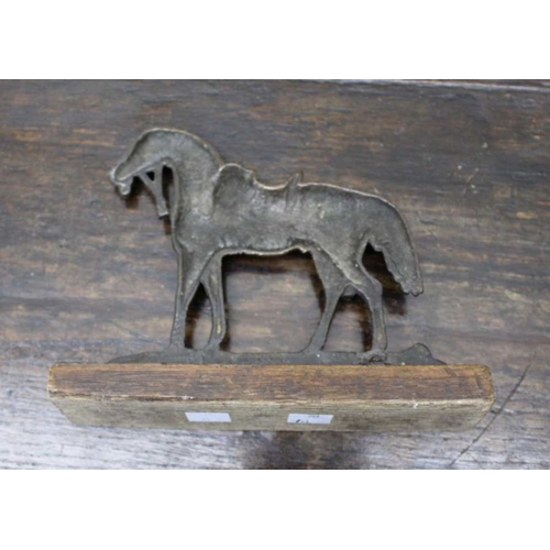 121 - A cast iron fire dog with male torso finial, 45cm high and a cast iron horse hearth ornament (2)