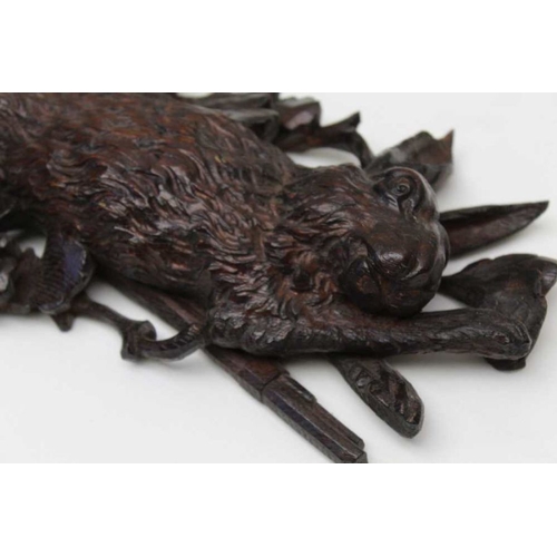 123 - A pair of 19th century Black Forest carved wall mounts, comprising a fox and a rabbit upon rifle and... 