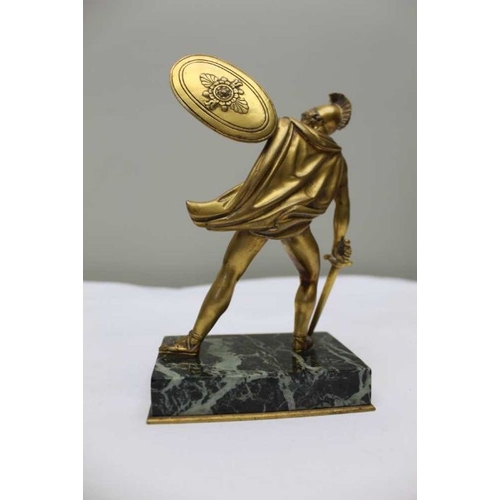 124 - A gilt bronze statue after the Antique, of a gladiator with shield and sword, on polished marble bas... 