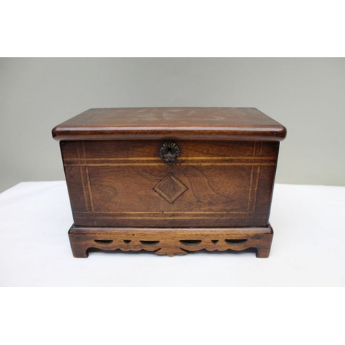 128 - A 19th century mahogany table casket, line inlay, on pierced platform base, the lid opens to reveal ... 