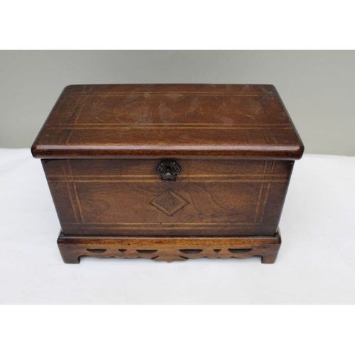 128 - A 19th century mahogany table casket, line inlay, on pierced platform base, the lid opens to reveal ... 