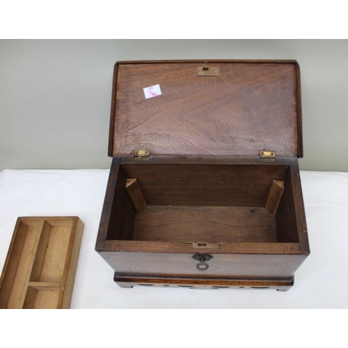 128 - A 19th century mahogany table casket, line inlay, on pierced platform base, the lid opens to reveal ... 