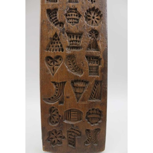 131 - A 19th century Dutch gingerbread mould, many small designs, include a cockerel, heart, barrel, boot,... 