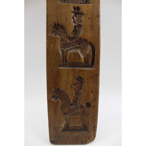 132 - A 19th century Dutch gingerbread board, bears four equestrian designs, 43cm x 8cm