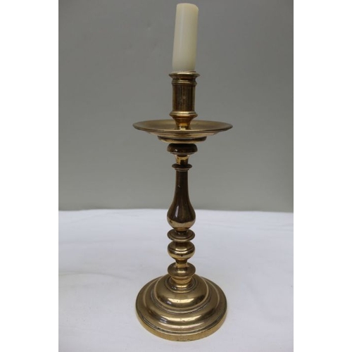 141 - A pair of 19th century brass candlesticks, with broad drip pans, 27cm high