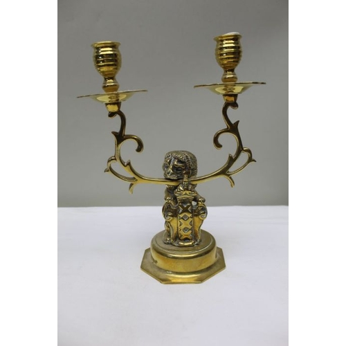 143 - A pair of 19th century Dutch brass twin branch candlesticks, the stem cast as a lion supporting the ... 