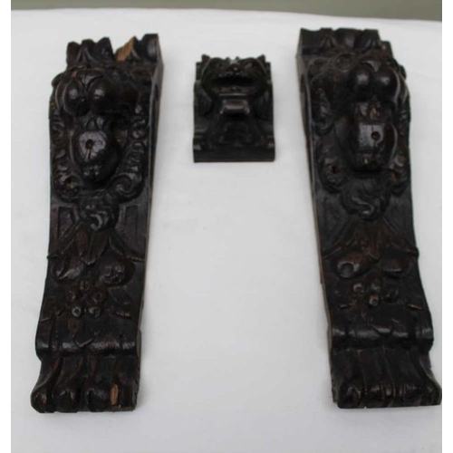 145 - A small carved oak lion mask, 10cm, together a pair of carved oak lion mounts, 31cm