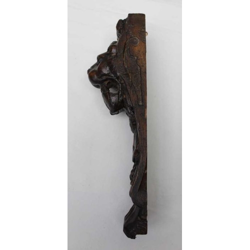 145 - A small carved oak lion mask, 10cm, together a pair of carved oak lion mounts, 31cm